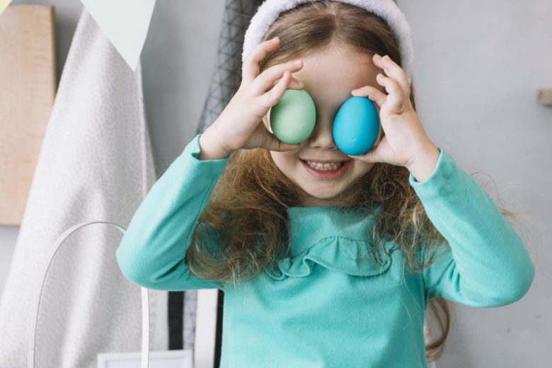 cute-girl-bunny-ears-holding-colored-eggs-eyes