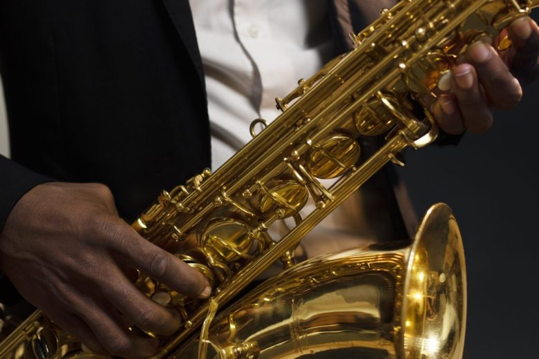 musician-suit-holding-saxophone-close-up